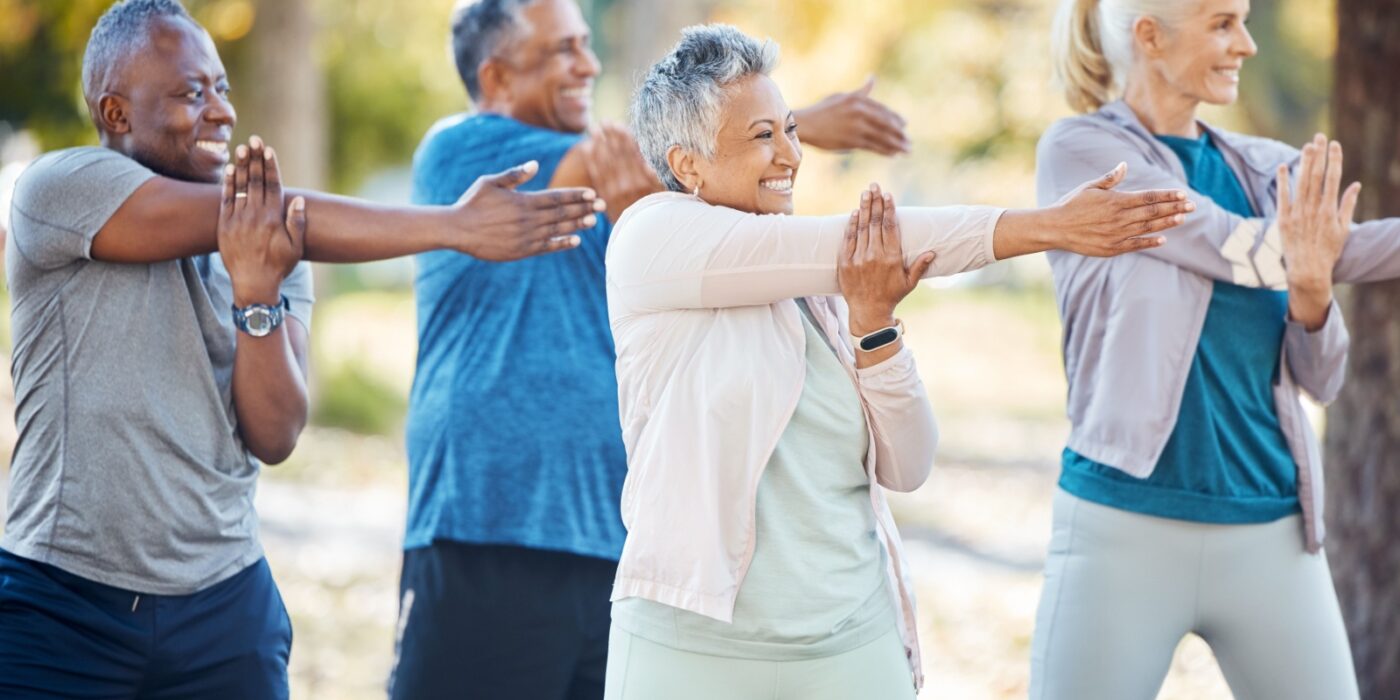 Senior people stretching before an exercise in an outdoor park or nature.