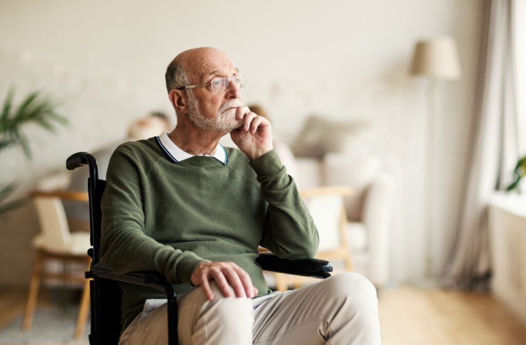 A senior with dementia sits in their wheelchair alone in their home, a sign of increased isolation