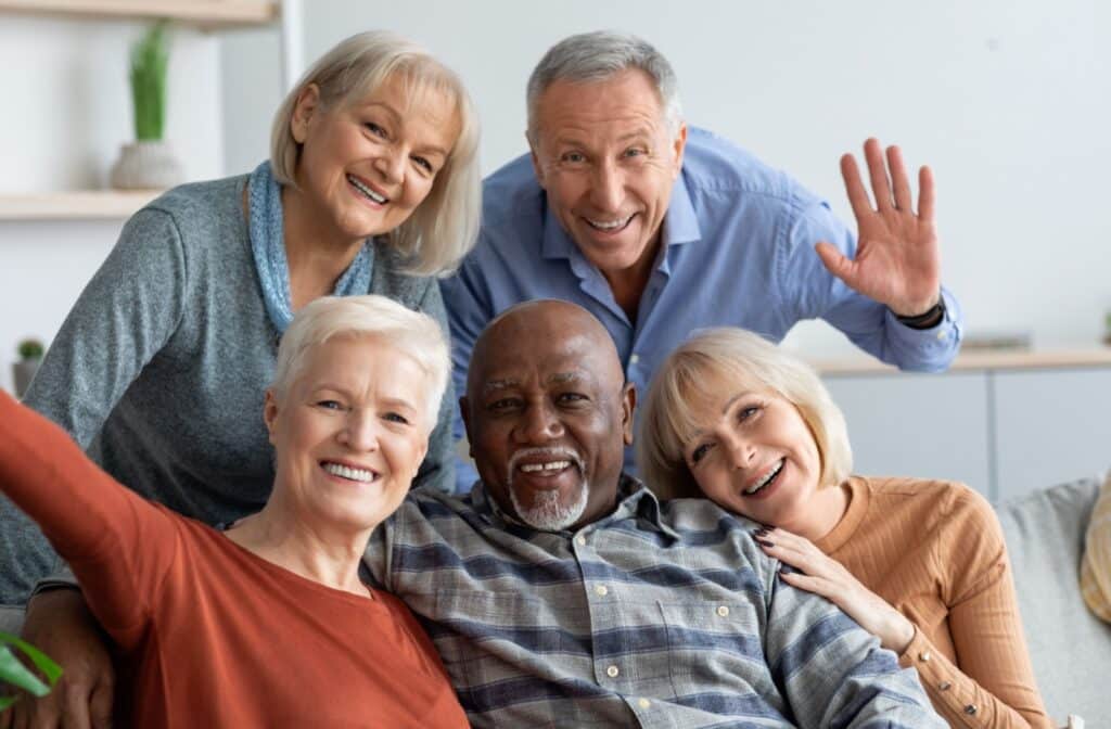 A group of friends smiling in assisted living.