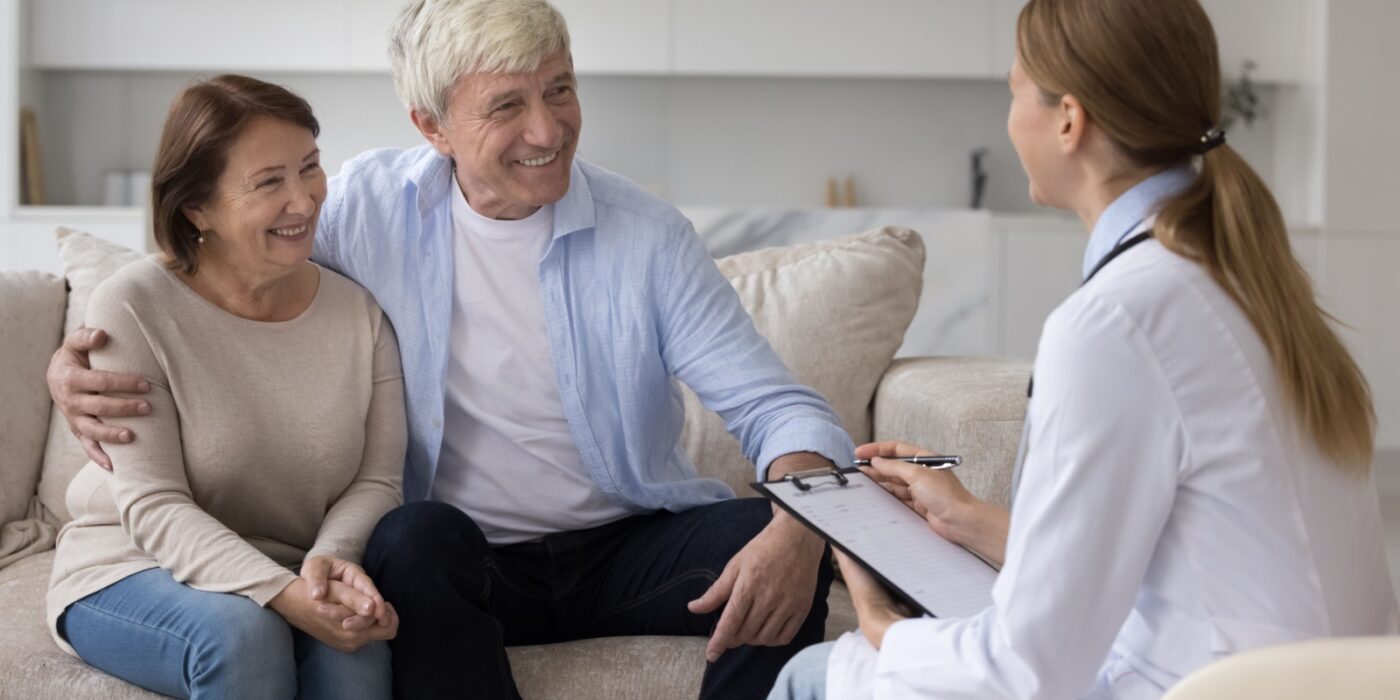 A senior couple chats with a doctor about a new dementia diagnosis and what that could mean for memory care support